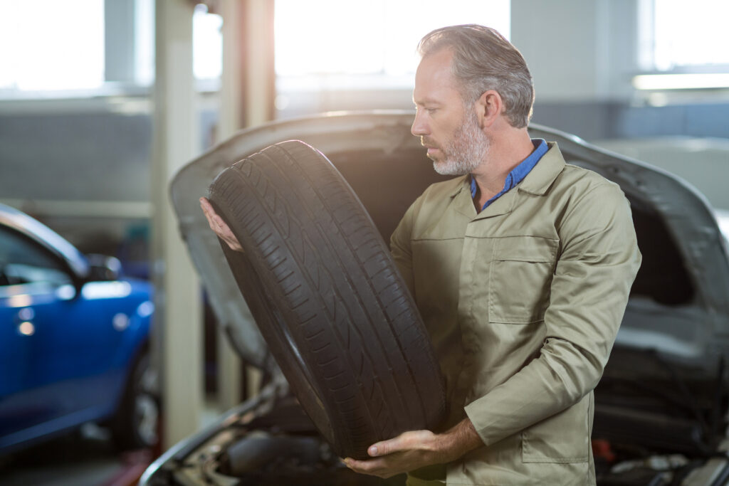 Mechanic holding a tyre
