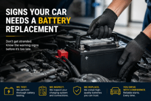 Technician replacing a car battery under the hood during a vehicle battery inspection in an auto repair shop.